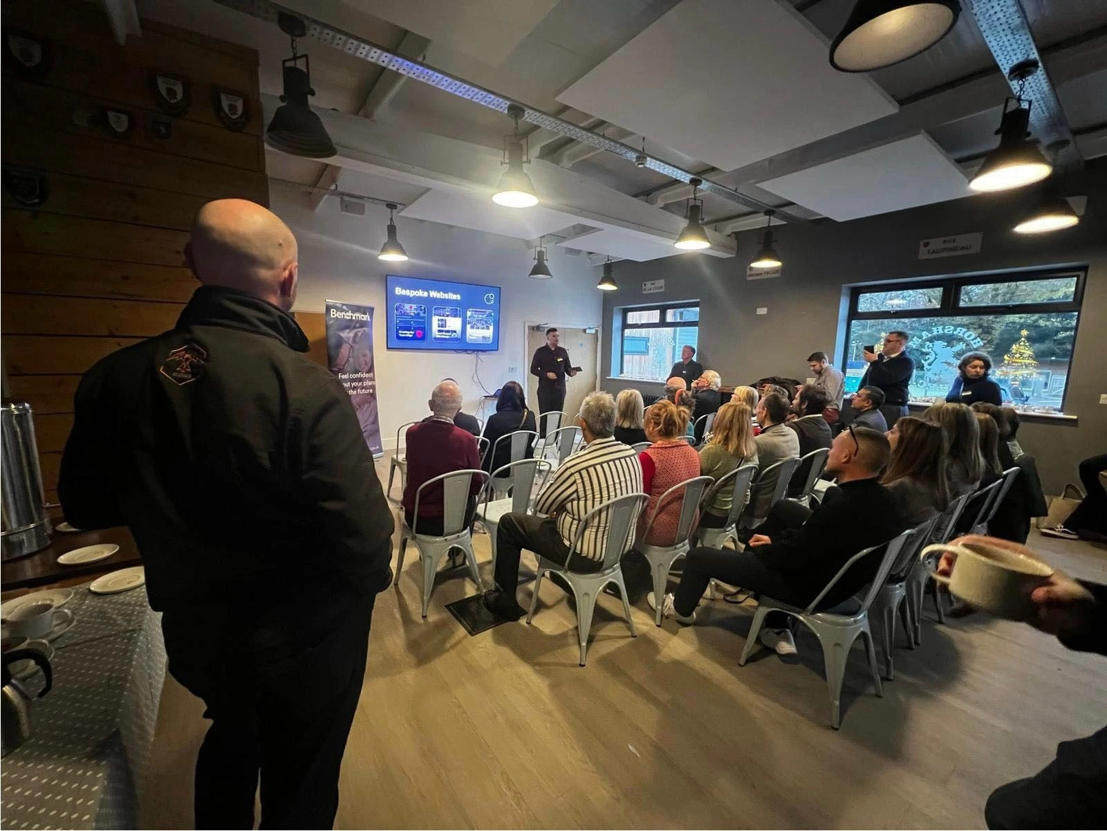 Stuart Ritchie's perspective of the crowd watching Lewis Harman speak at Horsham Rugby Business Group in November 2024 about building bespoke websites